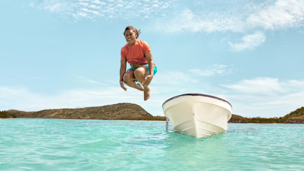 
Tourism-Fiji_A-local-iTaukei-woman-jumps-of-fishing-boat-in-the-Yasawa-Islands
